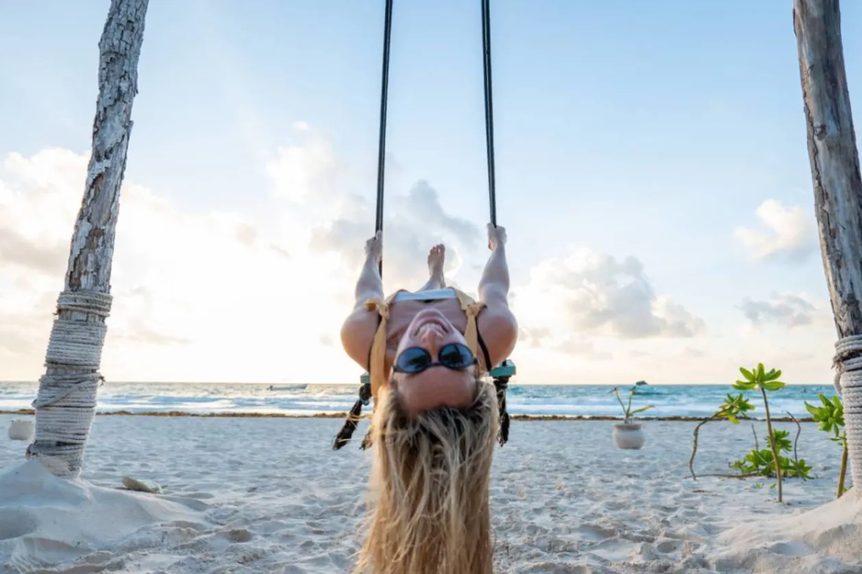 woman on swing having fun as part of kidulting wellness trends concept